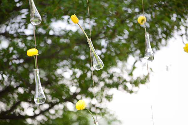 single stem flowers in hanging vases