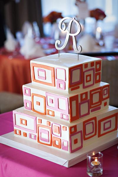 wedding cake with pink and orange accents