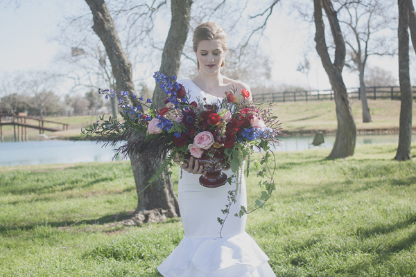 bride holding floral centerpiece
