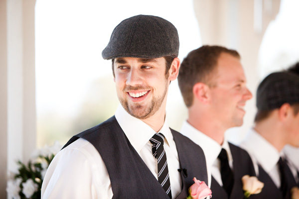 groom smiling wearing cap
