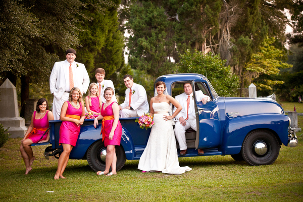 bridal party posing in blue ford truck